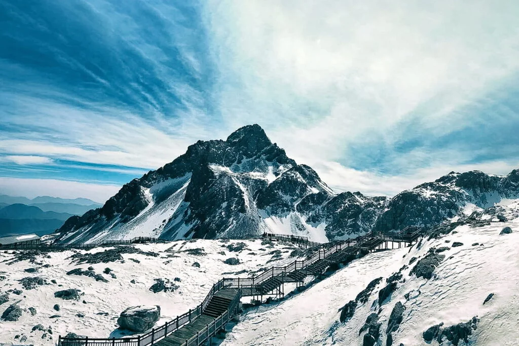 Majestic Jade Dragon Snow Mountain, adorned with fluffy clouds and pristine white snow