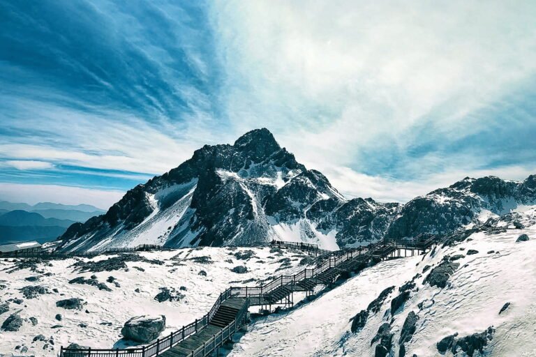 Majestic Jade Dragon Snow Mountain, adorned with fluffy clouds and pristine white snow