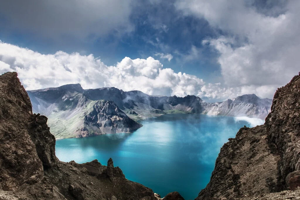 Tranquil Tianchi Lake in Changbai Mountain, with its mesmerizing blue-green water reflecting the surrounding beauty