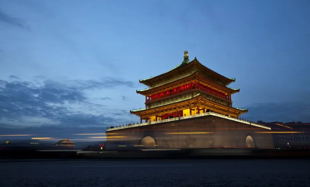 Bell Tower illuminated at night, with vibrant lights shining through the darkness