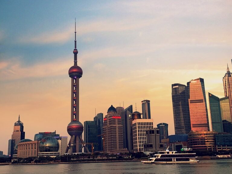 The Oriental Pearl Tower faces The Bund across the river at sunset