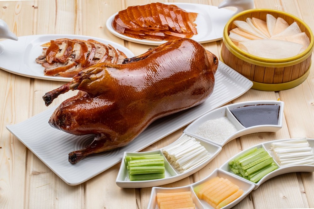 Peking roast duck is usually eaten with shredded green onions, cucumber slices and sweet noodle sauce