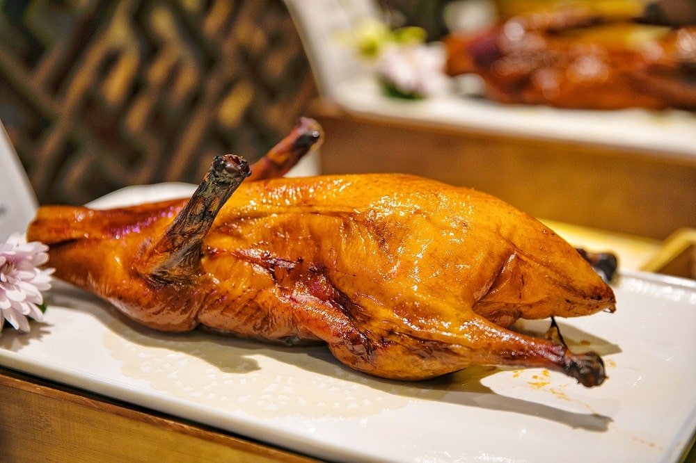 Crispy roast goose is marinated and roasted in a special oven