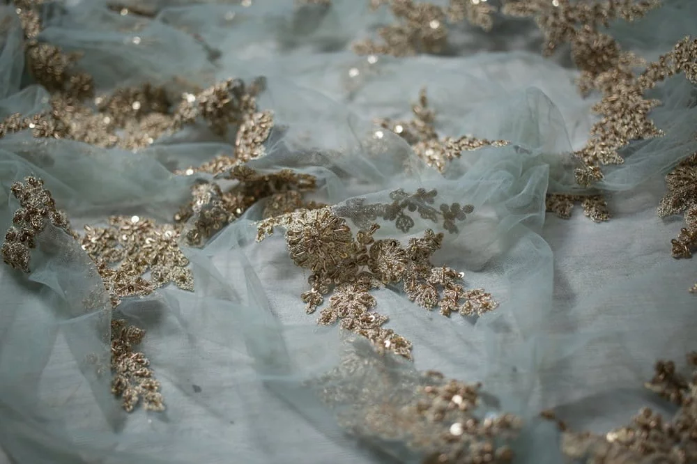 Embroidered small golden ornaments on very thin gauze