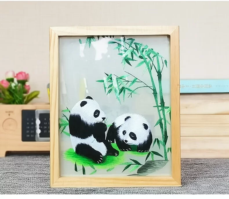 This is a Shu embroidery piece, with two pandas playing by the bamboo