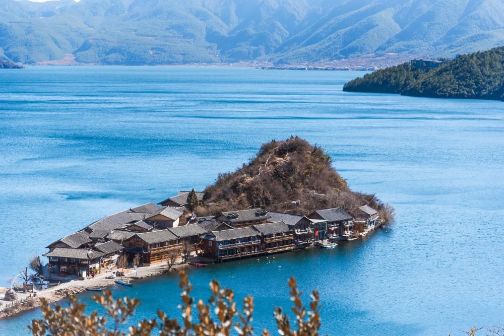 In Lugu Lake, Lijiang, there is a small island extending out with some Chinese-style buildings on it