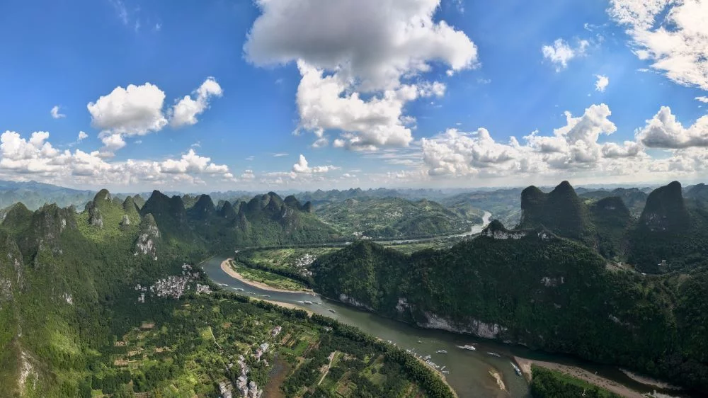 Aerial image of Yulong River winding through majestic karst mountains in Yangshuo