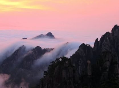 Majestic Huangshan Mountain at sunrise, adorned with clouds, revealing its breathtaking peak-500